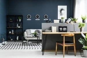 Sleek and stylish bark blue, grey and white home office set up in a studio flat