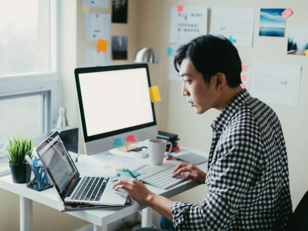 Canva – man working at a computer Man working at a computer in a home office