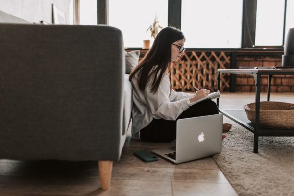 Canva - Woman Writing On Notebook With Laptop By Her Side